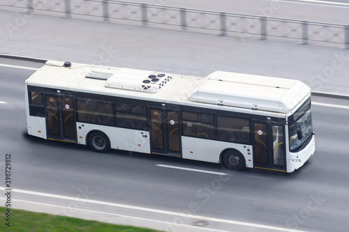 City bus travels on the highway, aerial view.