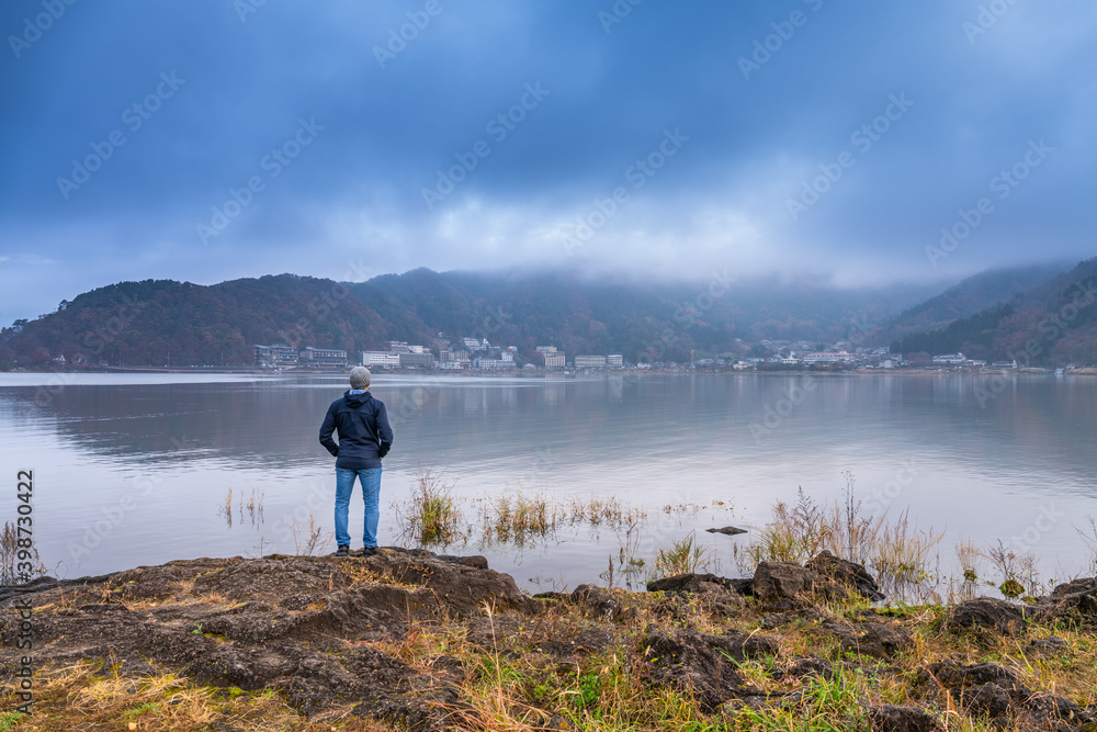 Man looking at lake Kawaguchi in Japan 