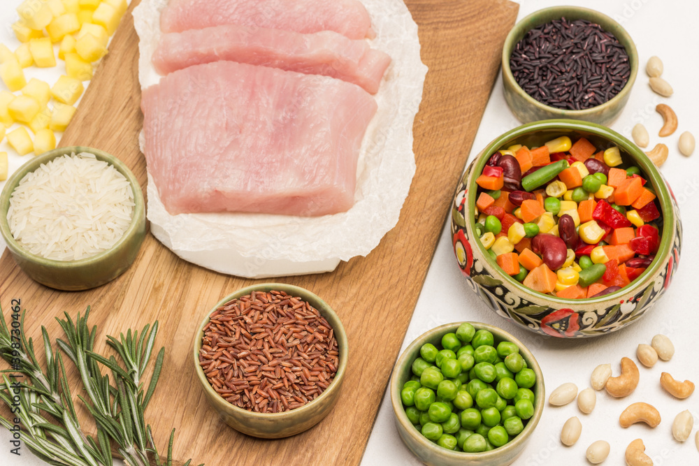 Turkey meat with vegetable mix. Black, brown and white rice in bowls Turkey meat with vegetable mix. Black, brown and white rice in bowls
