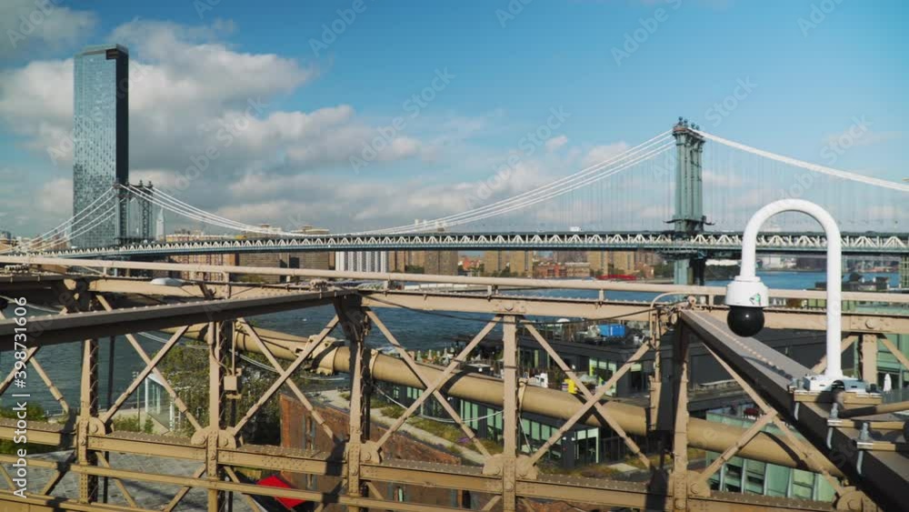View of the Manhattan Bridge from the Brooklyn Bridge pedestrian walkway - Pan shot View of the Manhattan Bridge from the Brooklyn Bridge pedestrian walkway - Pan shot