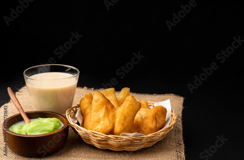 patongo or deep-fried dough and steamed custard with soy milk On a black background photo