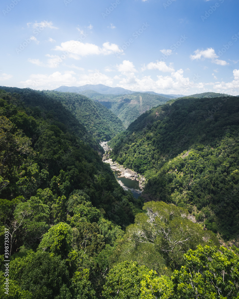 Barron Falls valley with lush rainforest and river flowing through 