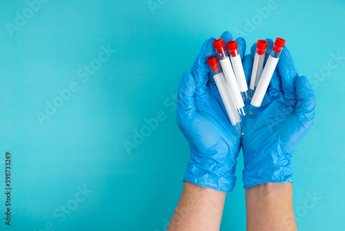 top view of doctor holding sample in test tube.