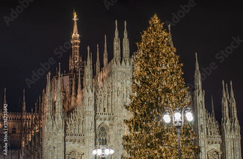 Duomo square in December illuminated by the large Christmas tree placed in front of the cathedral.Milan,Italy