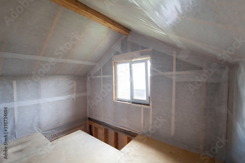 The walls of the frame house are sheathed with a vapor barrier membrane