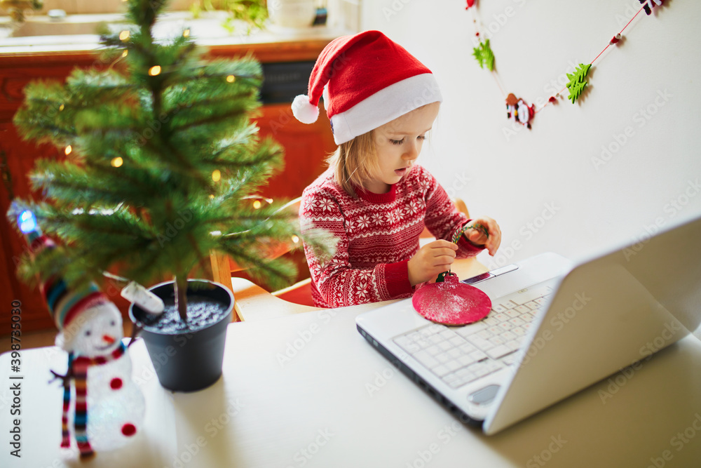 Kid using computer to communicate with friends or elderly relatives on Christmas or New Year Kid using computer to communicate with friends or elderly relatives on Christmas or New Year