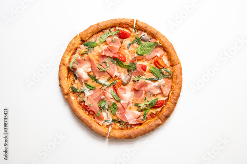 Pizza with prosciutto, cherry, arugula and basil isolated on white background