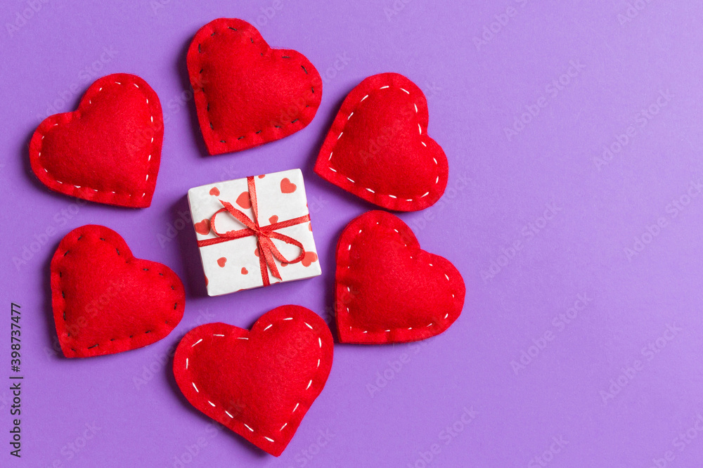 Holiday composition of gift boxes and red textile hearts on colorful background with empty space for your design. Top view of Valentine's Day concept Holiday composition of gift boxes and red textile hearts on colorful background with empty space for your design. Top view of Valentine's Day concept