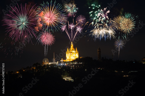 Fireworks near Tibidabo church on mountain in Barcelona. Spain