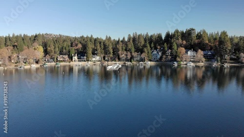 Wallpaper Mural Aerial panning view over the calm reflective surface of lake arrowhead waterfront properties, sunny, autumn day, in California, USA - low panning, drone shot Torontodigital.ca