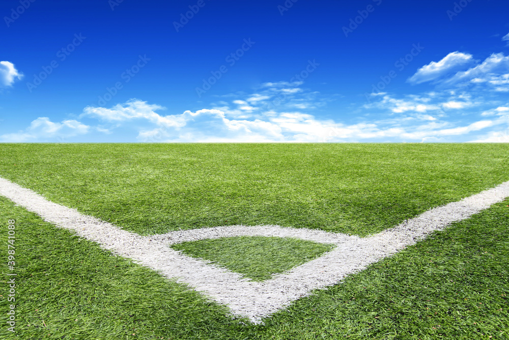 Football and soccer field grass stadium Blue sky background