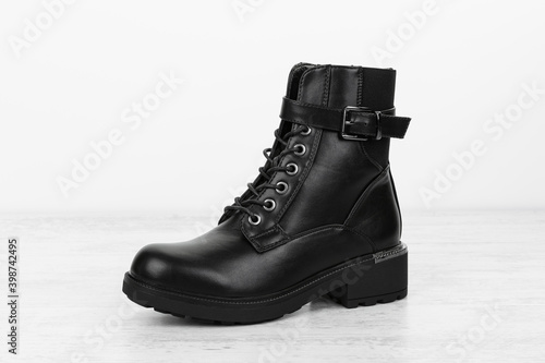 Elegant fashionable women's boot made of artificial leather on white background