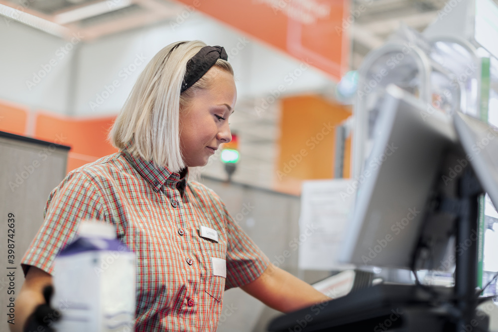 Smiling woman working at till Smiling woman working at till