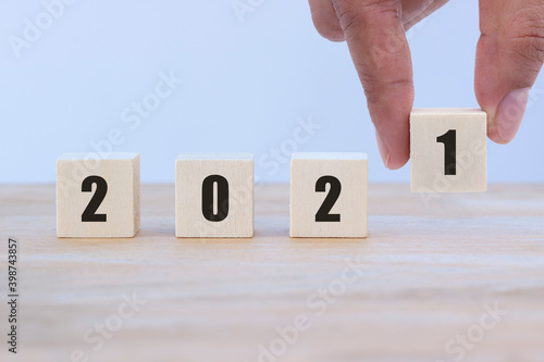 Wallpaper Mural Hand's man put number and copy space using as background, wooden cube to changing the number from 2020 to 2021 on wood table. Torontodigital.ca