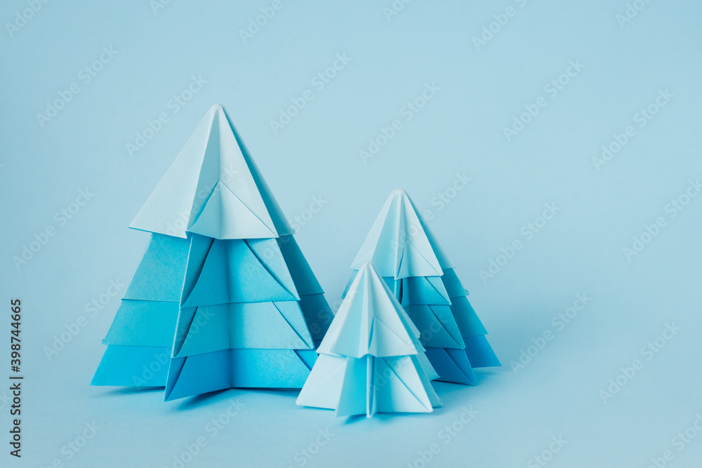 Simple origami 3D Christmas tree, step 20. Match the details from the largest at the bottom to the smallest at the top. You can use glue to hold it in place or leave it as it is to keep the tree lush.