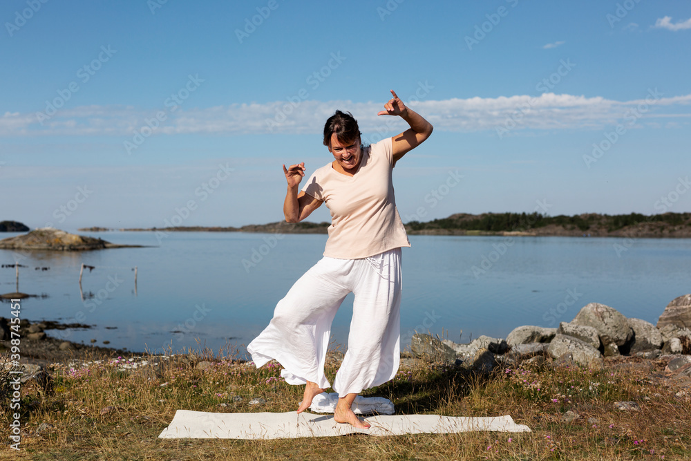 Woman doing yoga at sea