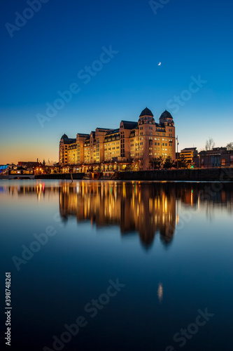 An old warehouse at Oslo habour seen at a half-moon night