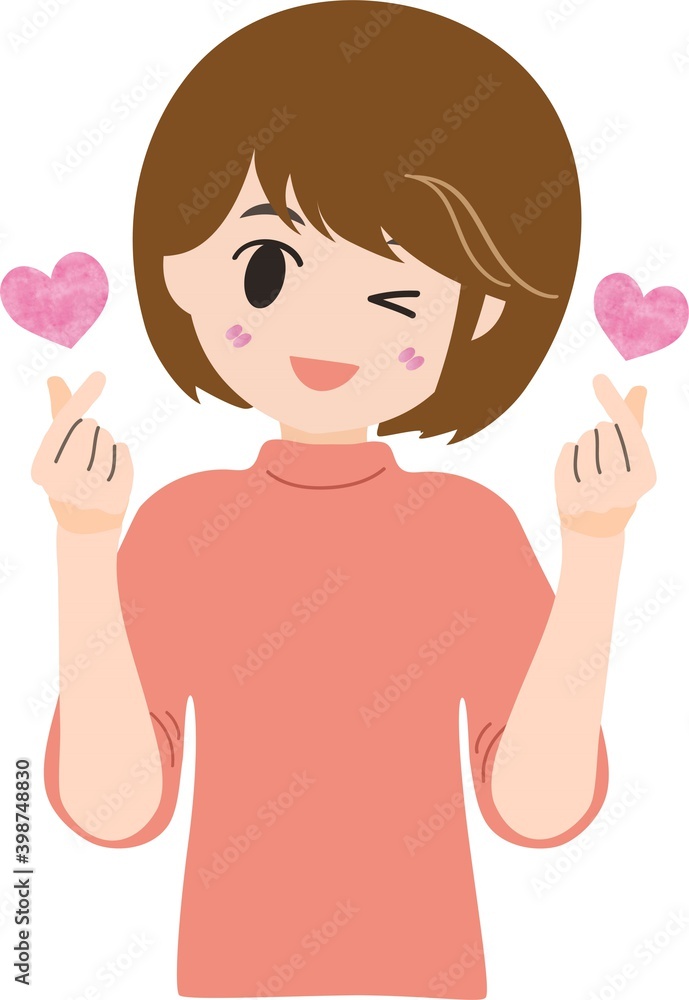 指でハートをつくるショートヘアの可愛い女性