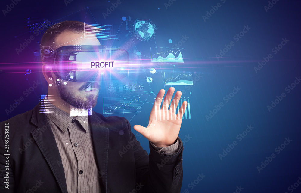 Businessman looking through Virtual Reality glasses with PROFIT inscription, new business concept Businessman looking through Virtual Reality glasses with PROFIT inscription, new business concept