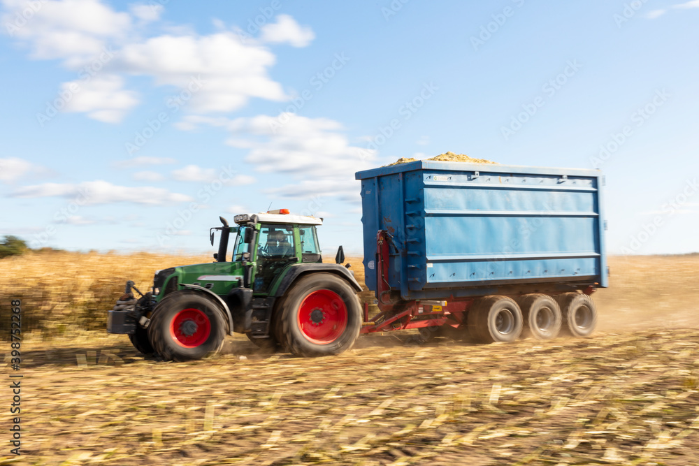 Tractor with trailer on field Tractor with trailer on field