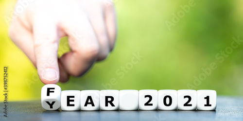 Hand turns dice and changes the expression "year 2021" to "fear 2021".