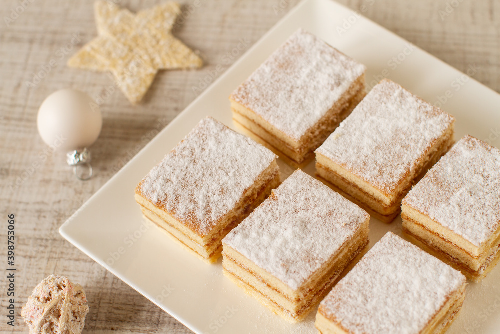 A square slices of festive Christmas white cake with vanilla cream filling