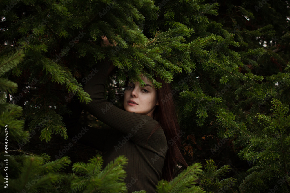 Woman relaxing at fir tree. Space for text Woman relaxing at fir tree. Space for text