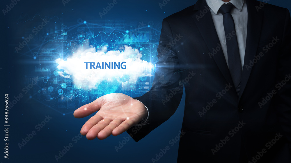 Hand of Businessman holding TRAINING inscription, successful business concept Hand of Businessman holding TRAINING inscription, successful business concept