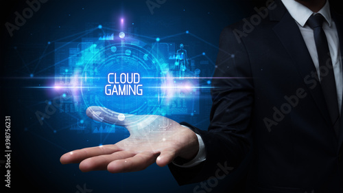 Man hand holding CLOUD GAMING inscription, technology concept