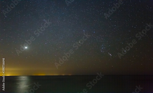 night starry sky above the sandy sea beach