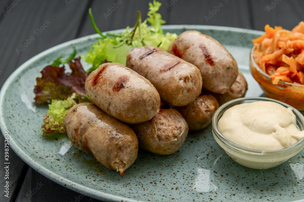 Grilled sausages on a plate with sauce Grilled sausages on a plate with sauce