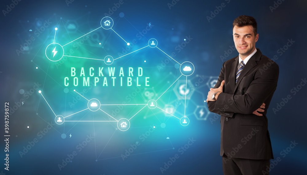 Businessman in front of cloud service icons with BACKWARD COMPATIBLE inscription, modern technology concept Businessman in front of cloud service icons with BACKWARD COMPATIBLE inscription, modern technology concept