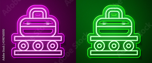 Glowing neon line Airport conveyor belt with passenger luggage, suitcase, bag, baggage icon isolated on purple and green background.  Vector.