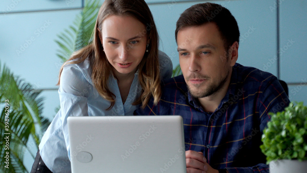 Business people working together on a computer in the office Business people working together on a computer in the office