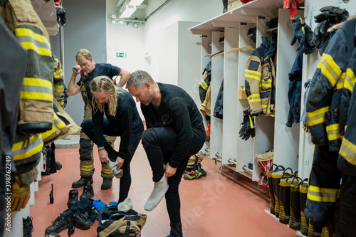 Firefighters changing in locker