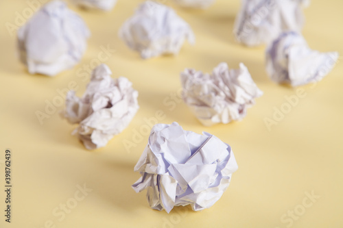 Set of crumpled paper balls  on an isolated yellow background.