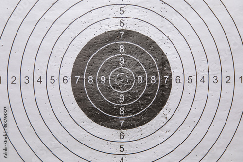 practice shooting range target with bullet holes from gun shot