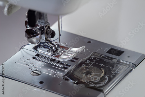 Metallic sewing machine foot. Studio light macro photo