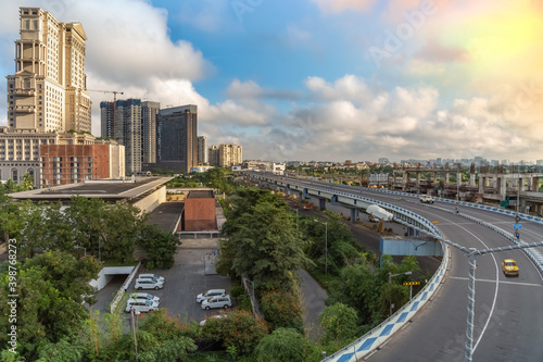 Fototapeta Naklejka Na Ścianę i Meble -  Aerial view of city flyover with high rise buildings and Kolkata cityscape at sunrise