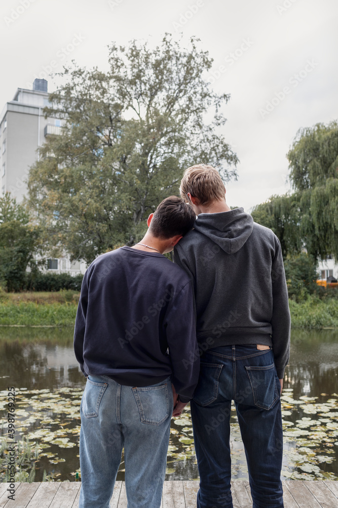 Rear view of two teenage boys standing together Rear view of two teenage boys standing together