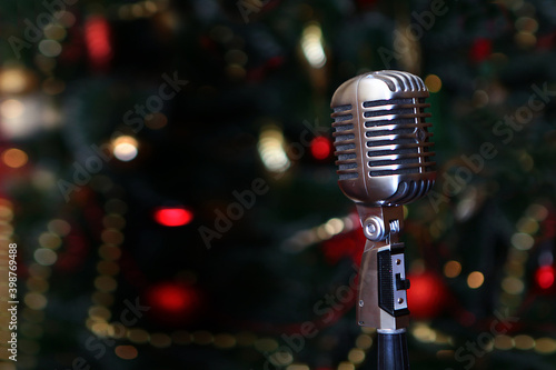 Photography Karaoke microphone on the background of a Christmas tree