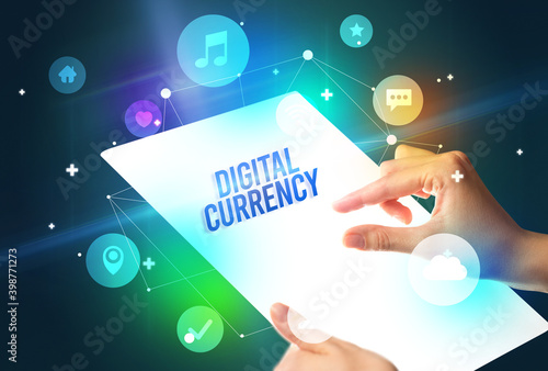 Holding futuristic tablet with DIGITAL CURRENCY inscription, new technology concept