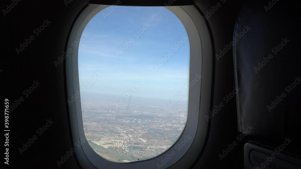 view through airplane window during take off
view through airplane window during take off