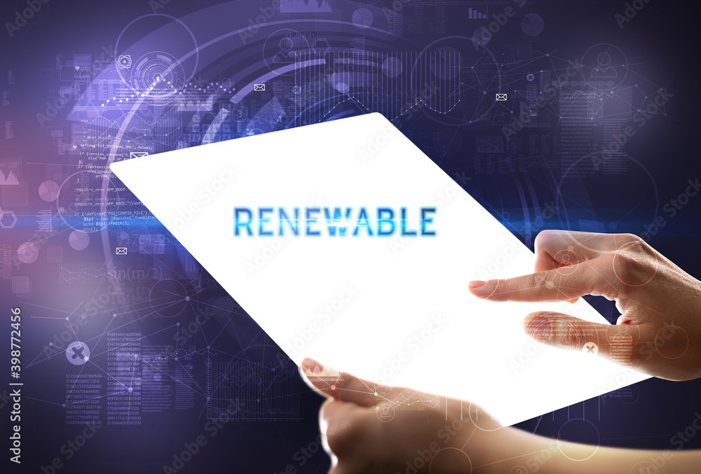 Hand holdig futuristic tablet with RENEWABLE inscription, new technology concept Hand holdig futuristic tablet with RENEWABLE inscription, new technology concept