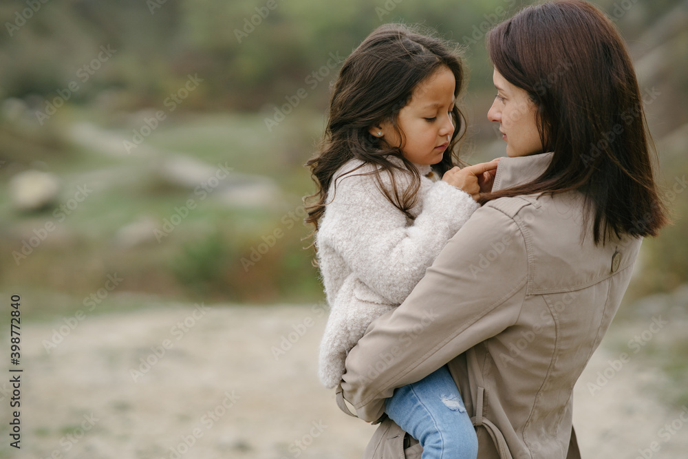 Sensual photo. Cute little girl. People walks outside. Woman in a brown coat. Sensual photo. Cute little girl. People walks outside. Woman in a brown coat.
