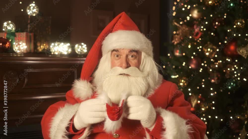 Happy Santa Claus take off medical mask during virtual meeting. End of the pandemic. Health care. Online chat conference. Remote communication. Close up portrait. Slow motion version 4K Happy Santa Claus take off medical mask during virtual meeting. End of the pandemic. Health care. Online chat conference. Remote communication. Close up portrait. Slow motion version 4K
