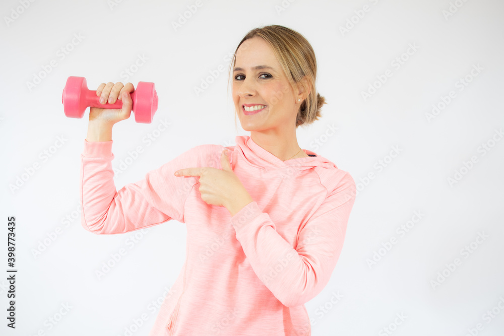 Beautiful young fitness woman holding dumbbell. Studio shot. Beautiful young fitness woman holding dumbbell. Studio shot.