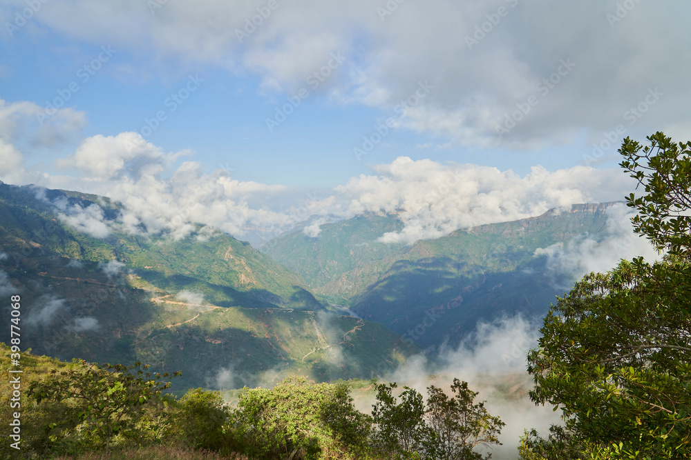 Mist rising from the moody dense rain forest in the hills of Barichara close to the equator in the andes mountains of Colombia, South America