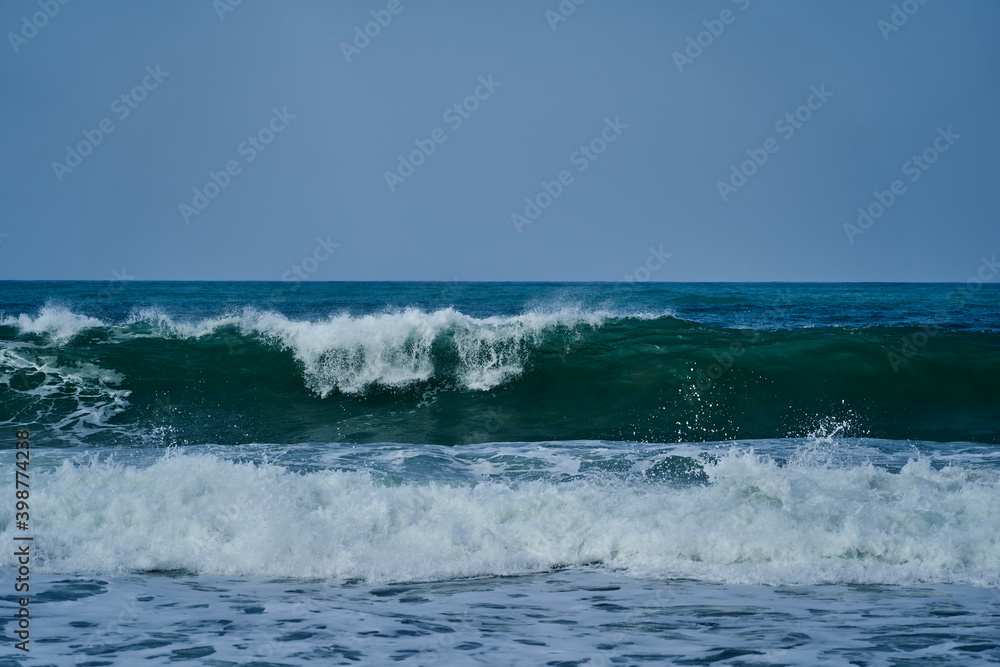 waves crushing in on the beach of the shoreline at Tayrona national park on the atlantic coast of Colombia in caribbean, South America