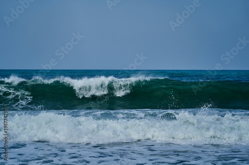 waves crushing in on the beach of the shoreline at Tayrona national park on the atlantic coast of Colombia in caribbean  South America